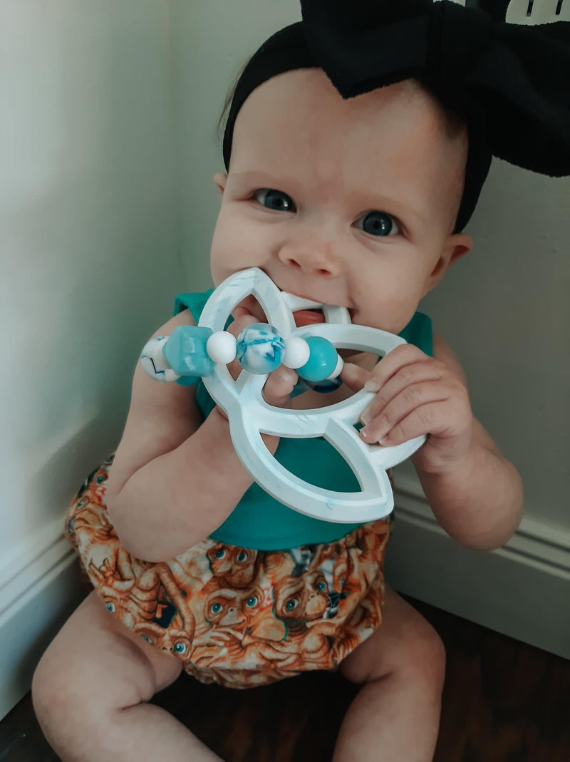 Baby chewing on our handmade baby lotus teether