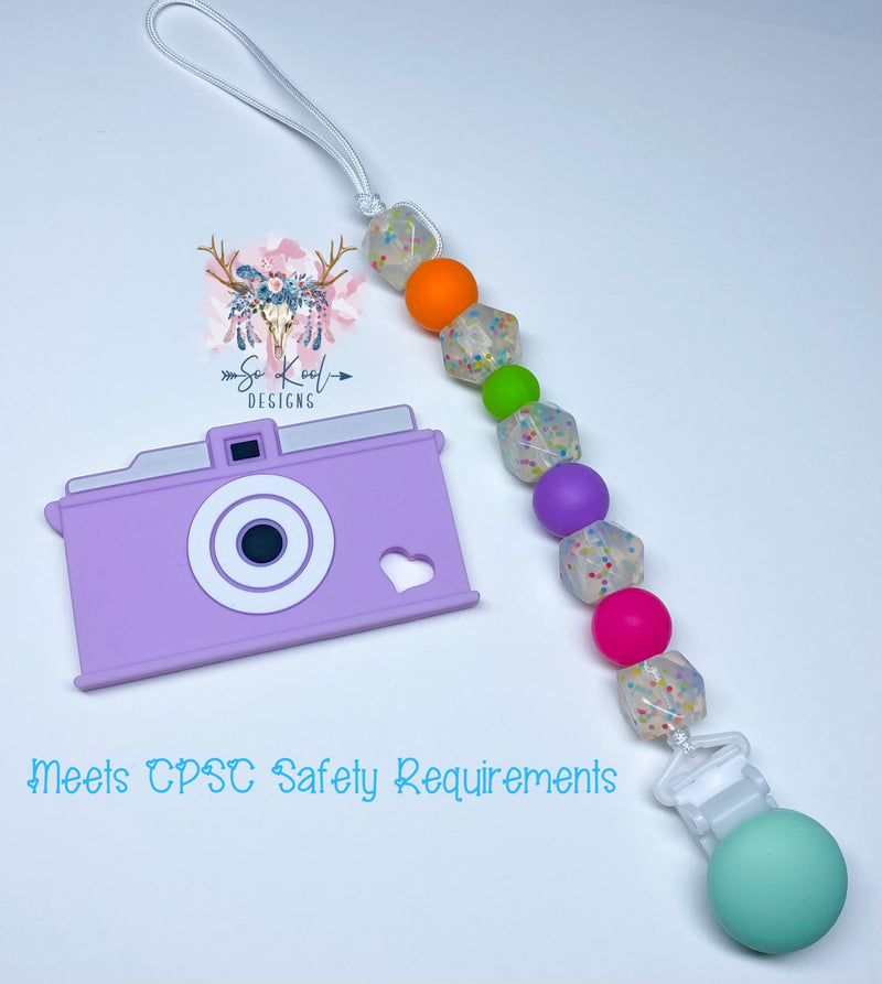 Purple camera teether with coordinating paci clip