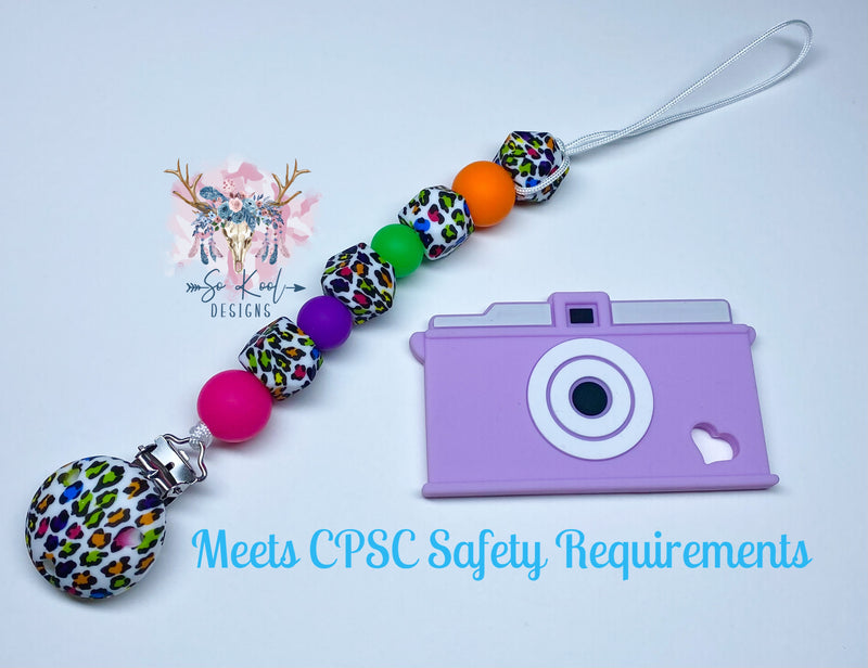 Purple camera teether with coordinating paci clip